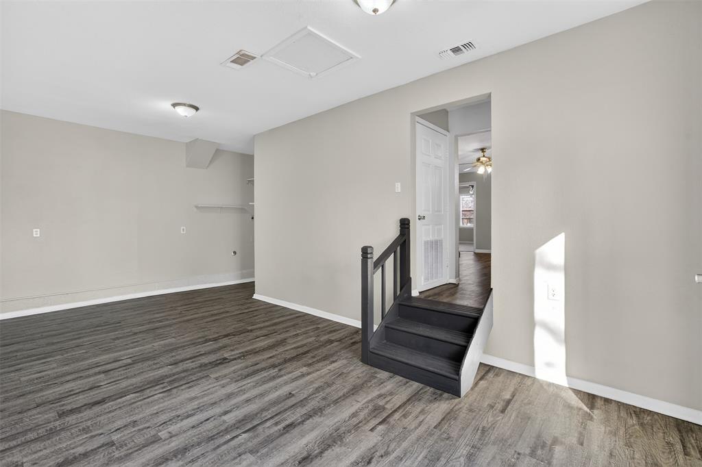 701 Harrison Lane Hurst, TX 76053 - Photo 25 of 29 a view of a hallway with wooden floor and staircase