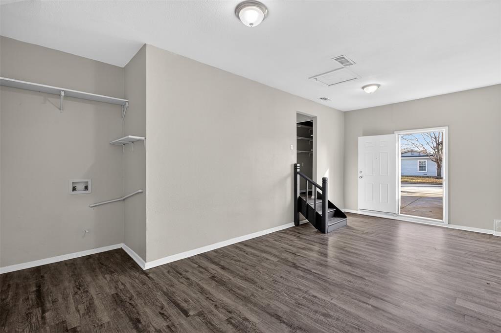 701 Harrison Lane Hurst, TX 76053 - Photo 26 of 29 an empty room with wooden floor and a window