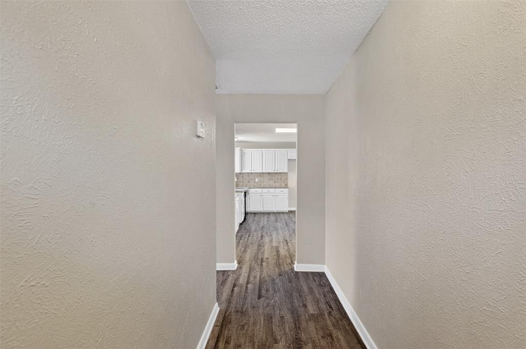 701 Harrison Lane Hurst, TX 76053 - Photo 4 of 29 a view of a hallway with wooden floor