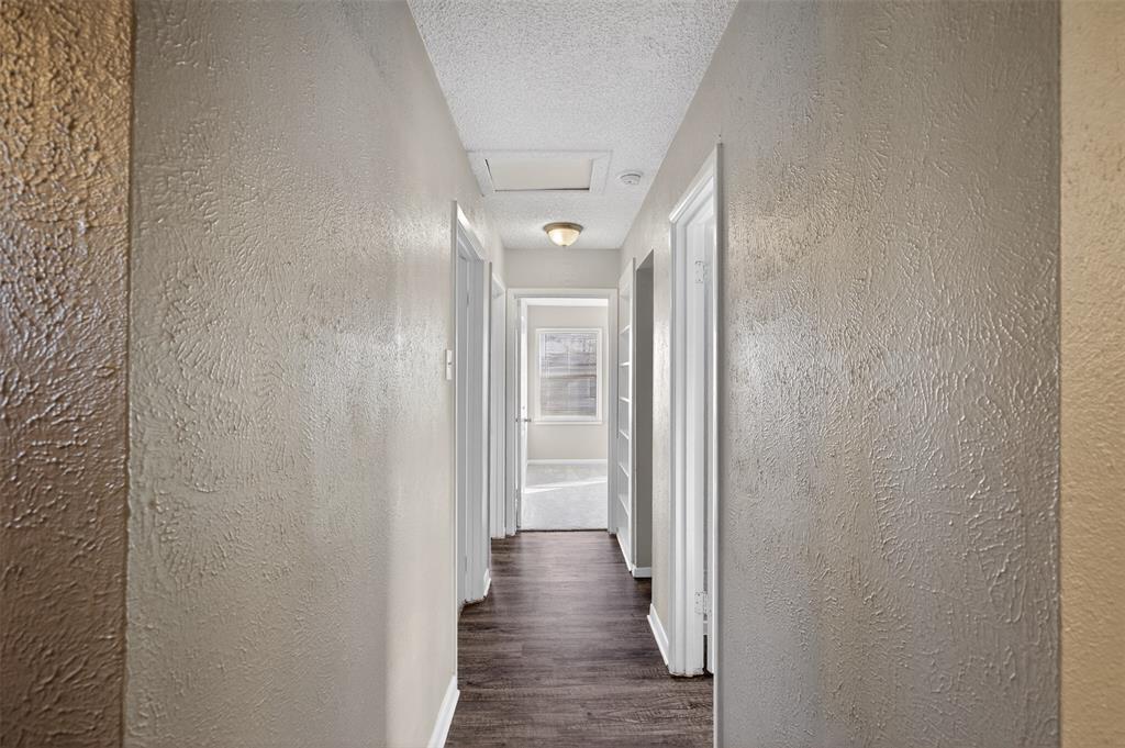 701 Harrison Lane Hurst, TX 76053 - Photo 5 of 29 a view of a hallway with wooden floor