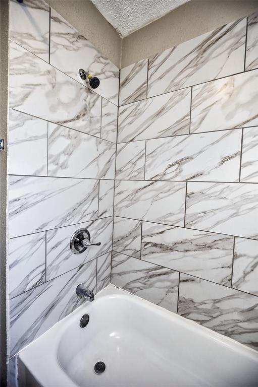 701 Harrison Lane Hurst, TX 76053 - Photo 7 of 29 a bathroom with a sink and a shower