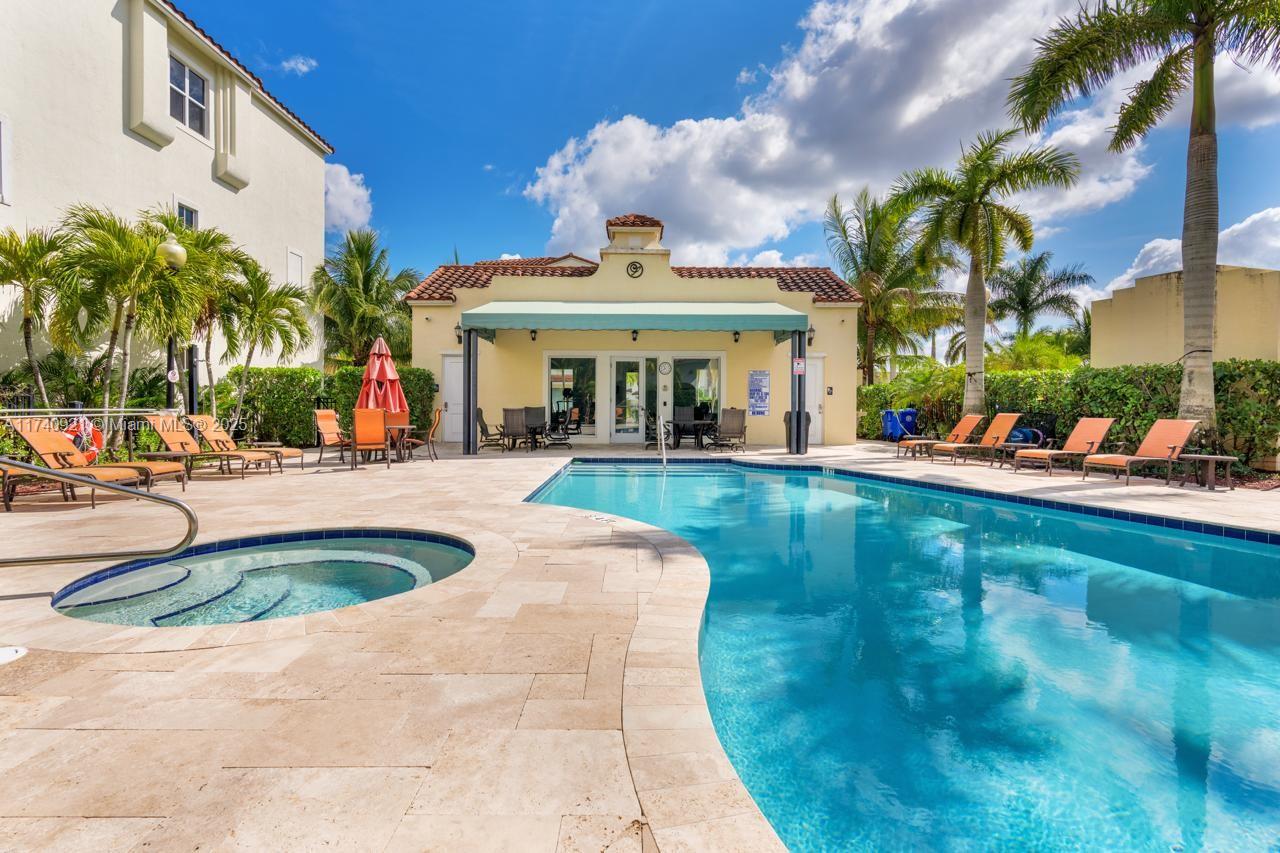 1799 Northwest 124th Way, Unit 1799 Pembroke Pines, FL 33028 - Photo 1 of 40 a view of a swimming pool with a patio