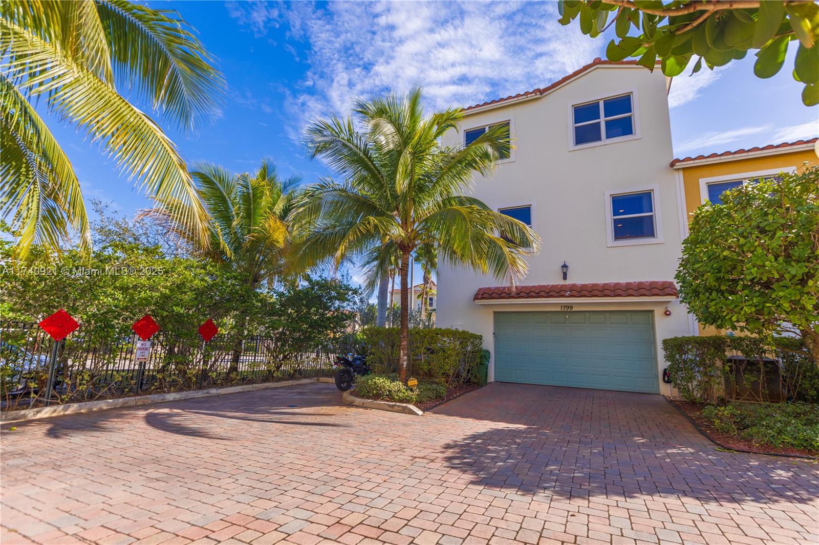 1799 Northwest 124th Way, Unit 1799 Pembroke Pines, FL 33028 - Photo 11 of 40 a front view of a house with a garage and a chair