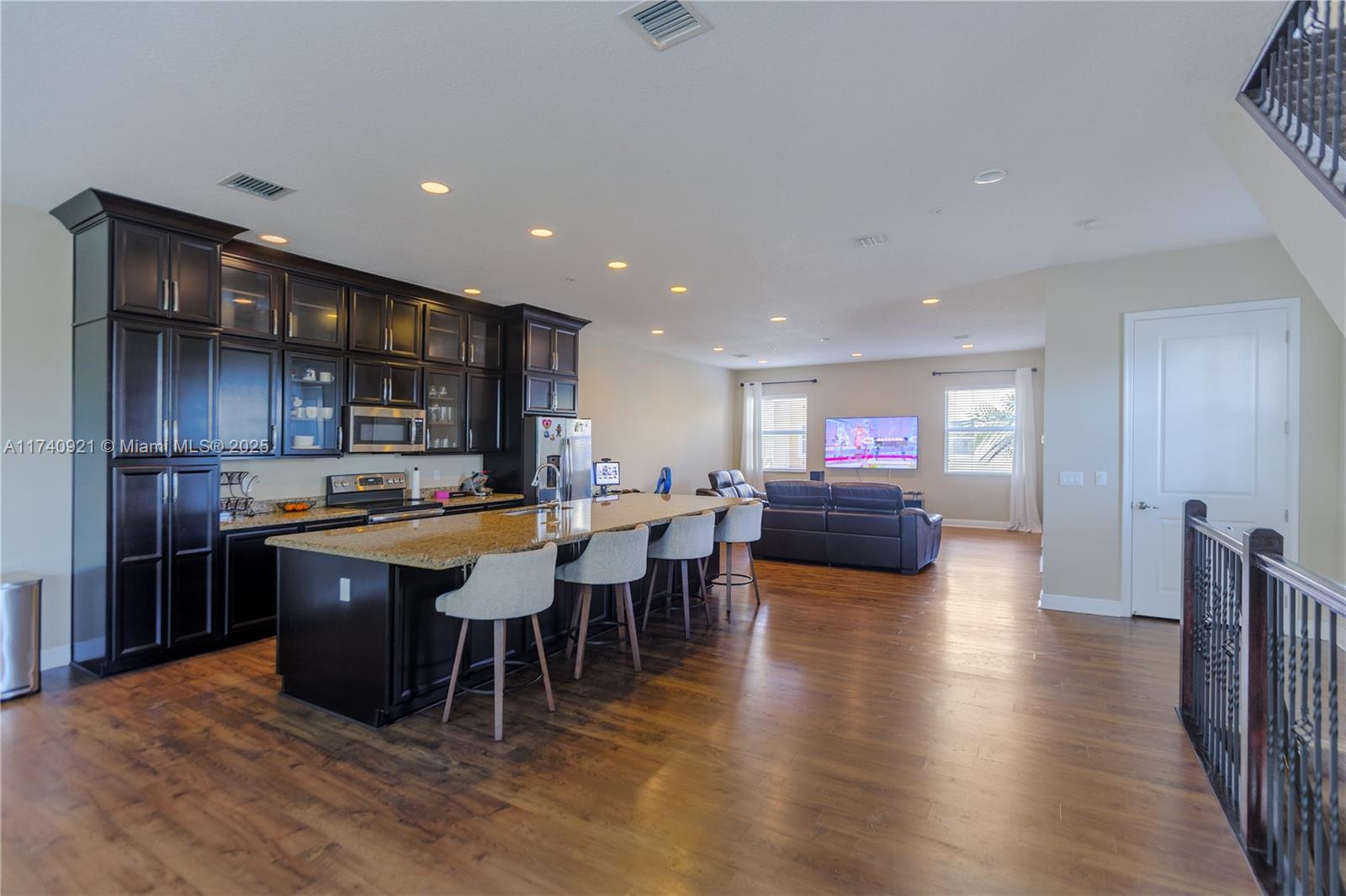 1799 Northwest 124th Way, Unit 1799 Pembroke Pines, FL 33028 - Photo 14 of 40 a large kitchen with a table and a refrigerator