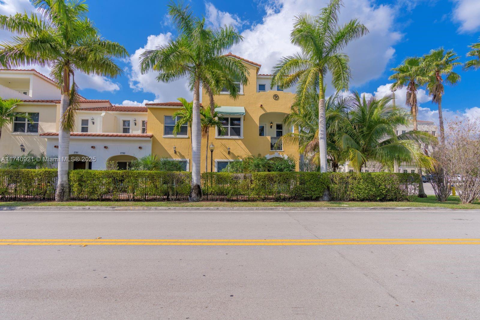 1799 Northwest 124th Way, Unit 1799 Pembroke Pines, FL 33028 - Photo 2 of 40 front view of house with palm trees and entryway