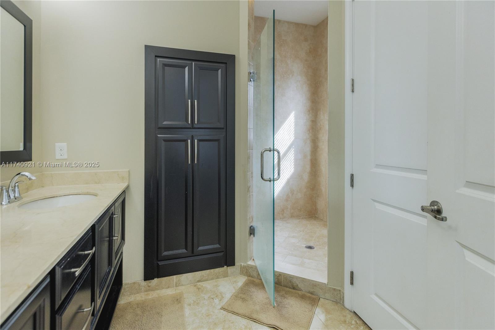 1799 Northwest 124th Way, Unit 1799 Pembroke Pines, FL 33028 - Photo 26 of 40 a bathroom with a granite countertop sink a mirror and shower