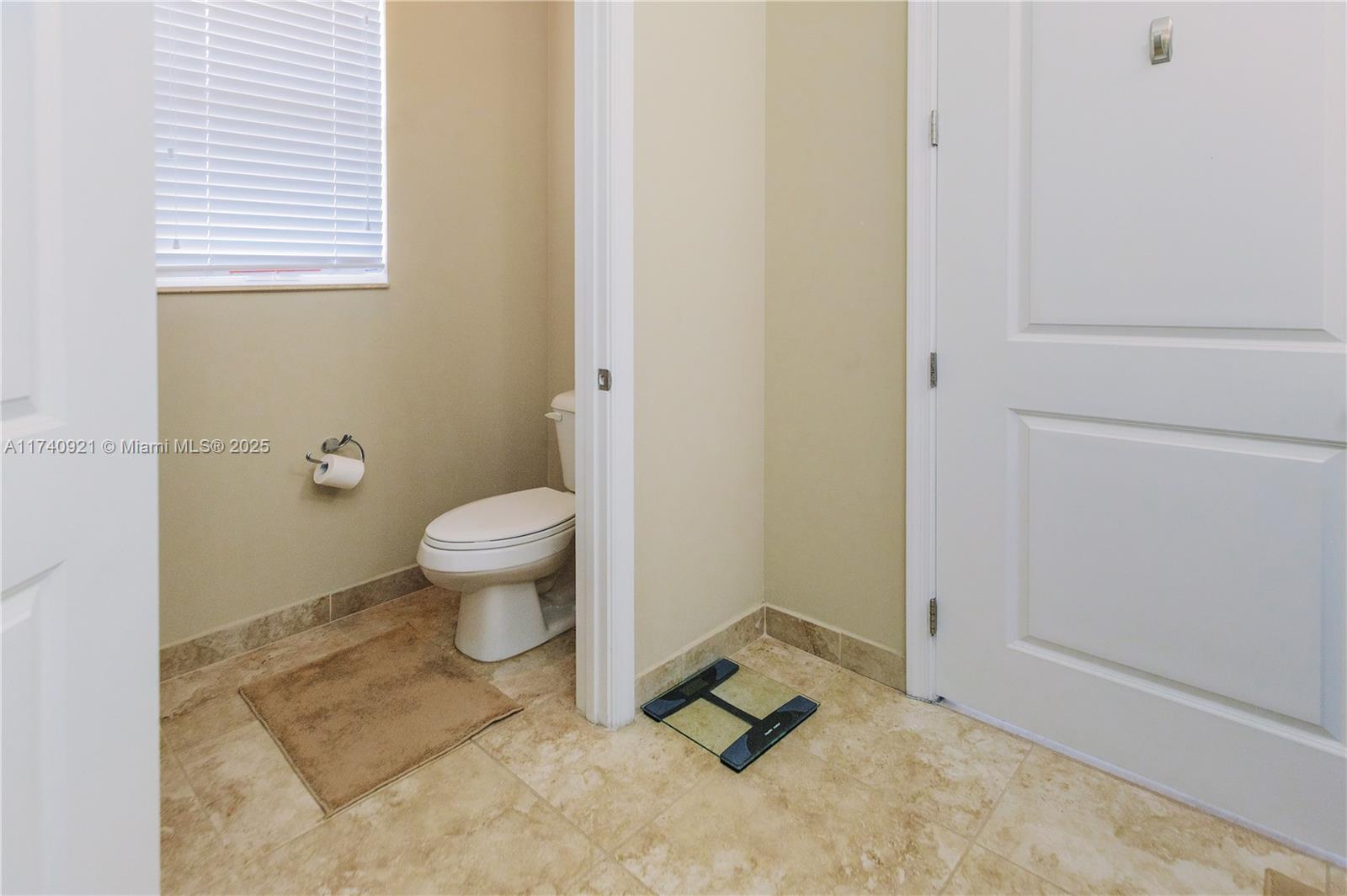 1799 Northwest 124th Way, Unit 1799 Pembroke Pines, FL 33028 - Photo 28 of 40 a bathroom with a toilet and a shower