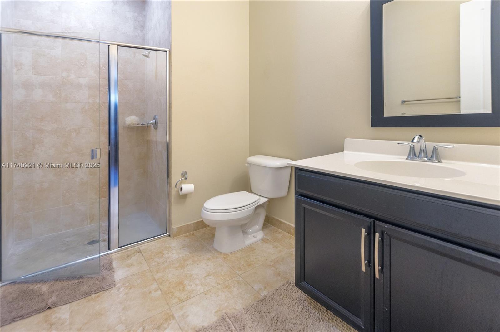 1799 Northwest 124th Way, Unit 1799 Pembroke Pines, FL 33028 - Photo 35 of 40 a bathroom with a sink a toilet and shower