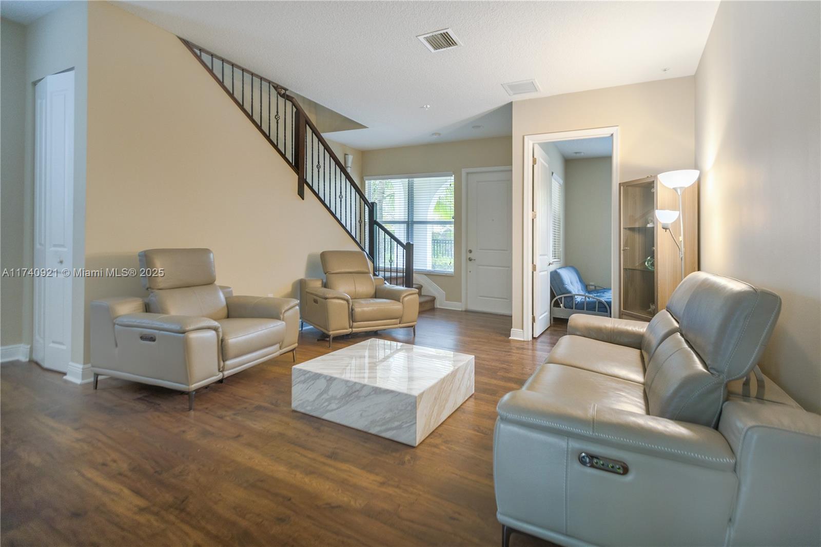 1799 Northwest 124th Way, Unit 1799 Pembroke Pines, FL 33028 - Photo 38 of 40 a living room with furniture and a wooden floor