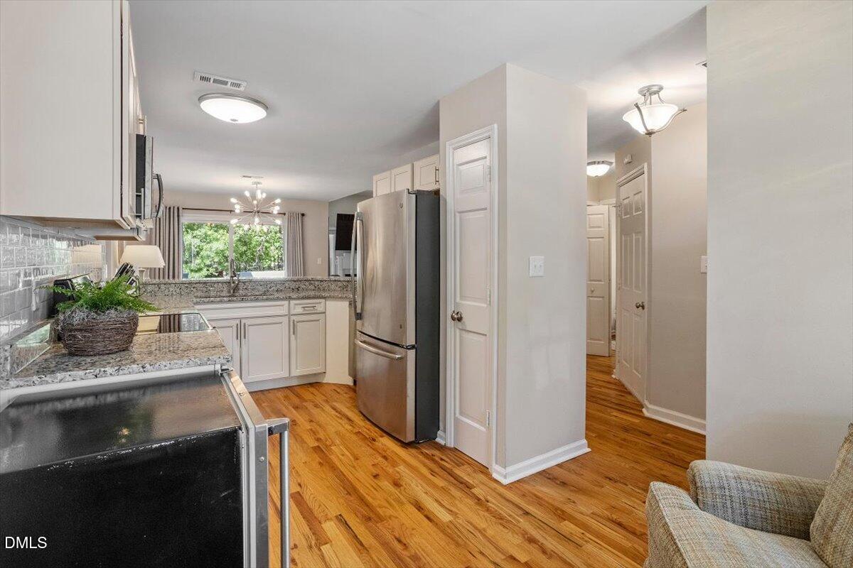 8321 Hempshire Place, Unit 103 Raleigh, NC 27613 - Photo 10 of 25 a kitchen with a refrigerator and a sink