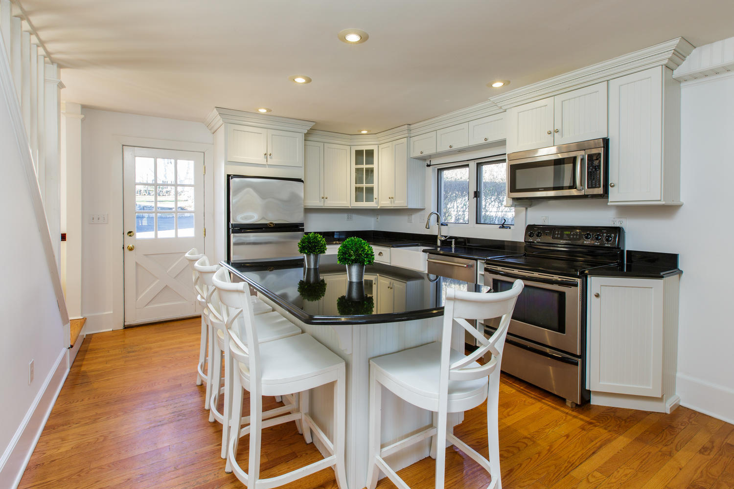 12 Roton Avenue Rowayton, CT 06853 - Photo 13 of 31 a kitchen with stainless steel appliances granite countertop a stove top oven a sink a dining table and chairs