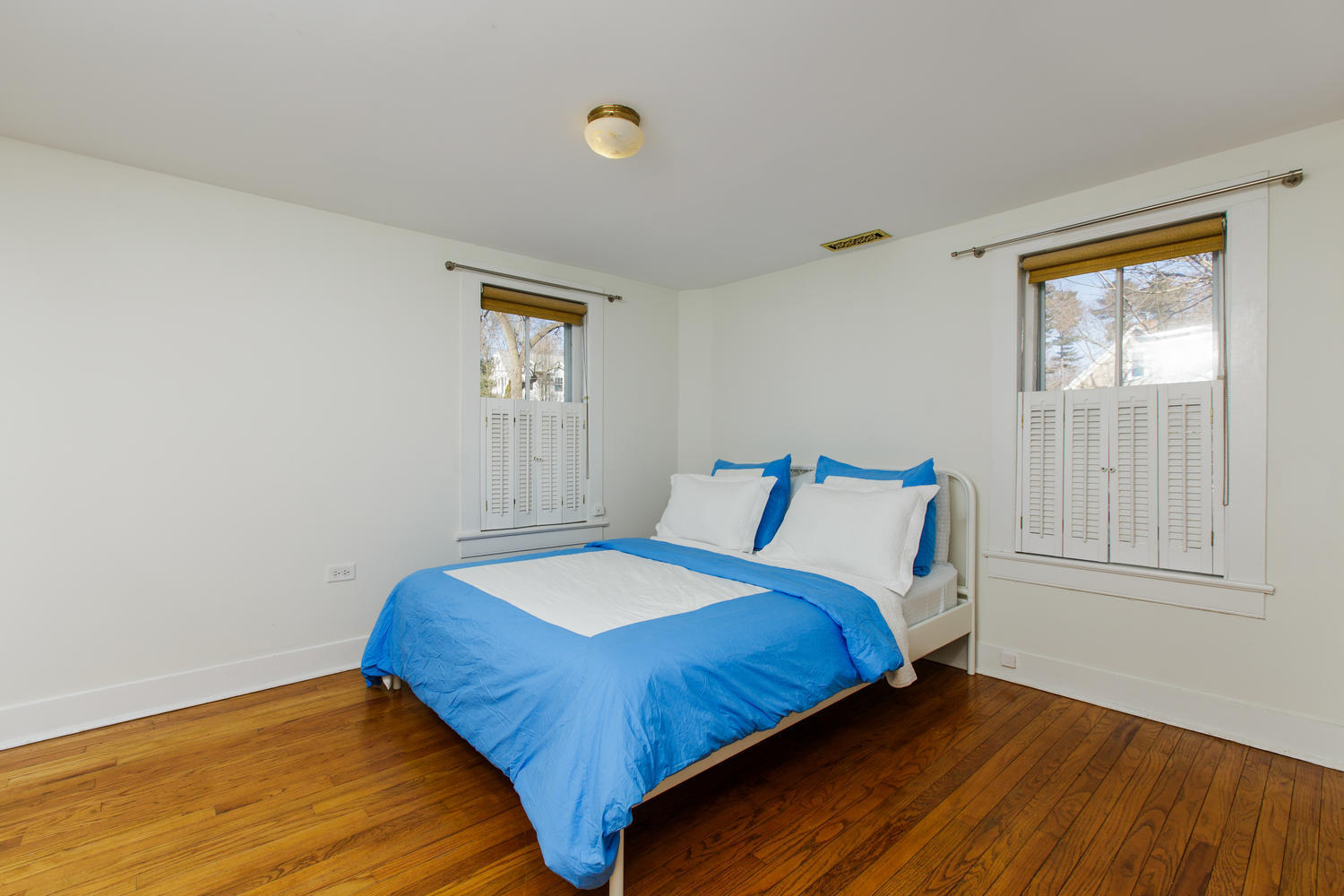 12 Roton Avenue Rowayton, CT 06853 - Photo 16 of 31 a bedroom with a bed and wooden floor