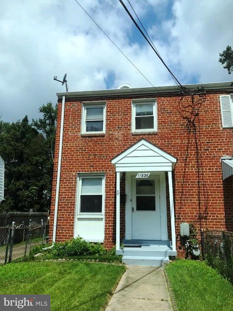 11936 Bluhill Road Silver Spring, MD 20902 - Photo 2 of 30 a front view of a house with a garden and plants