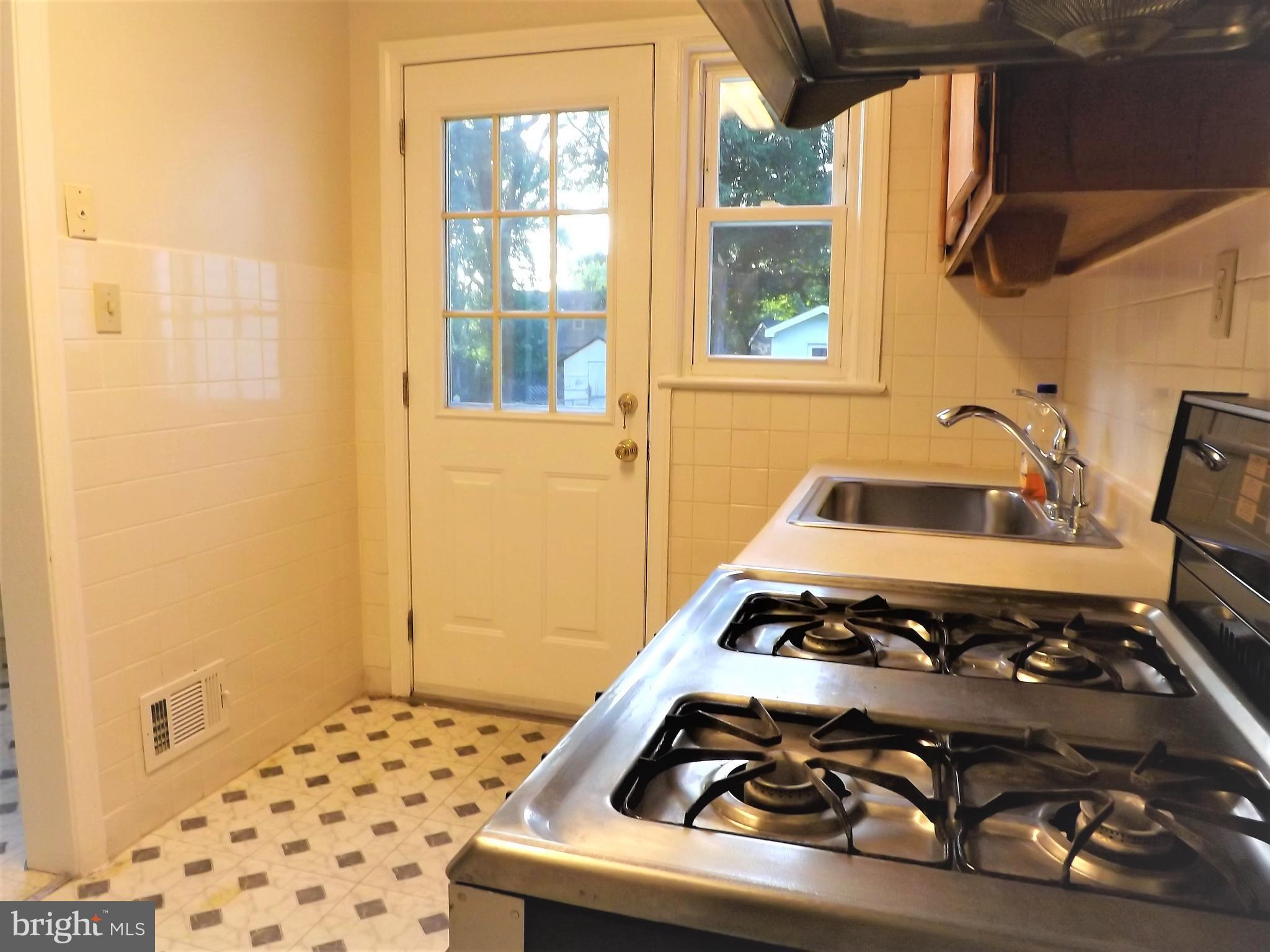 11936 Bluhill Road Silver Spring, MD 20902 - Photo 11 of 30 a bedroom with a bed and a window