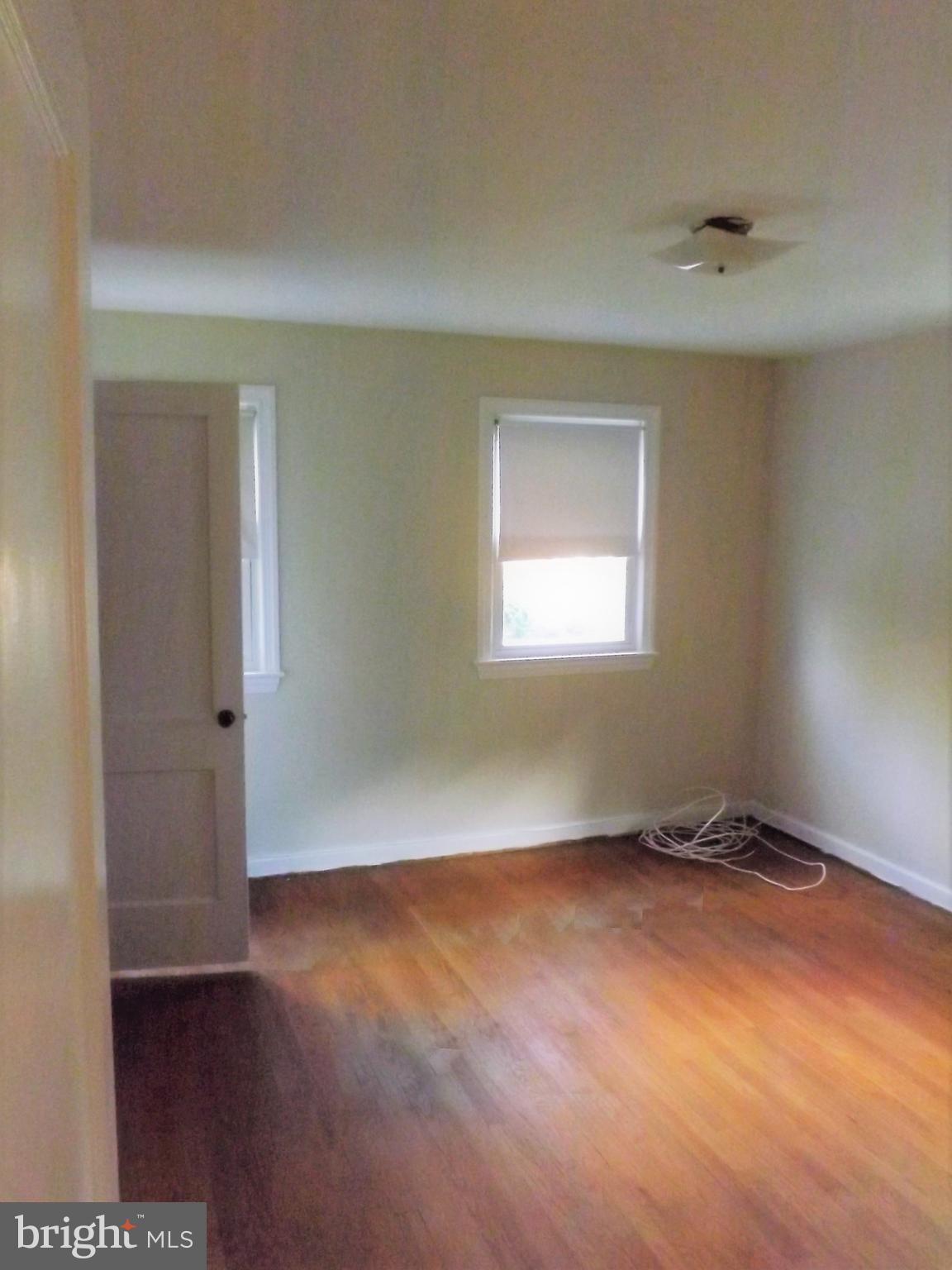 11936 Bluhill Road Silver Spring, MD 20902 - Photo 13 of 30 an empty room with wooden floor and windows