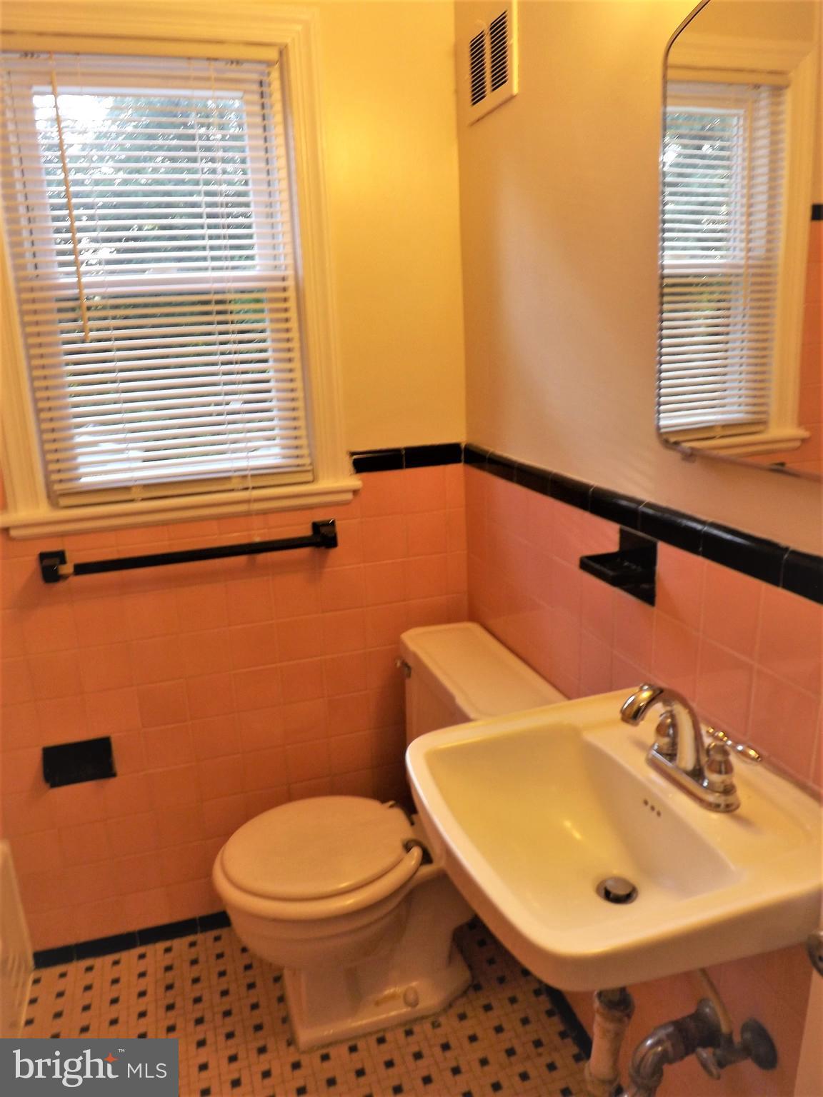 11936 Bluhill Road Silver Spring, MD 20902 - Photo 16 of 30 a bathroom with a sink a toilet and a mirror