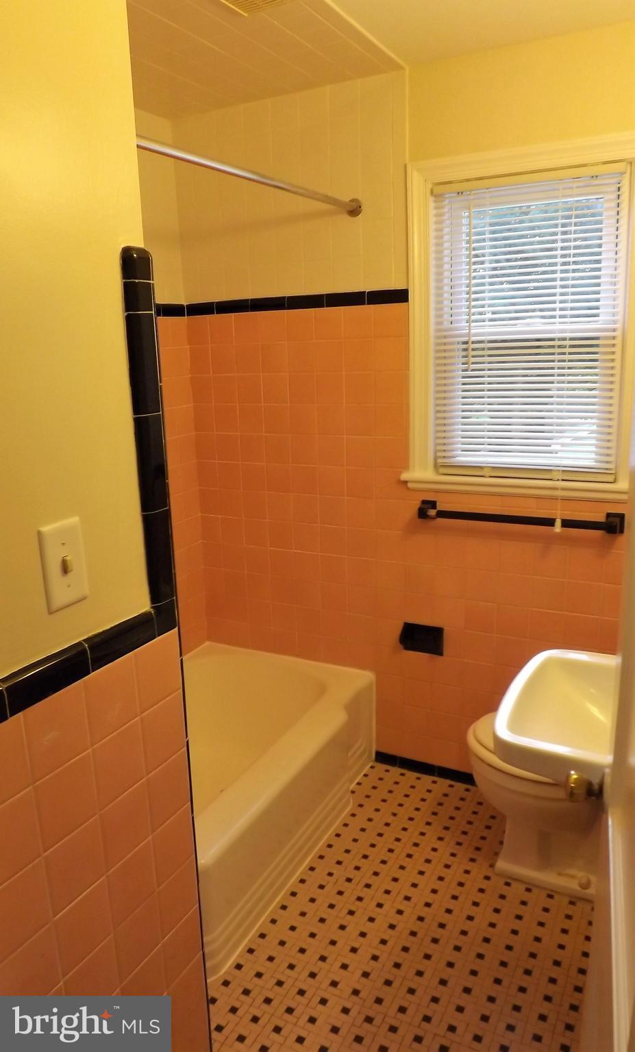 11936 Bluhill Road Silver Spring, MD 20902 - Photo 17 of 30 a bathroom with a sink a toilet a window and vanity