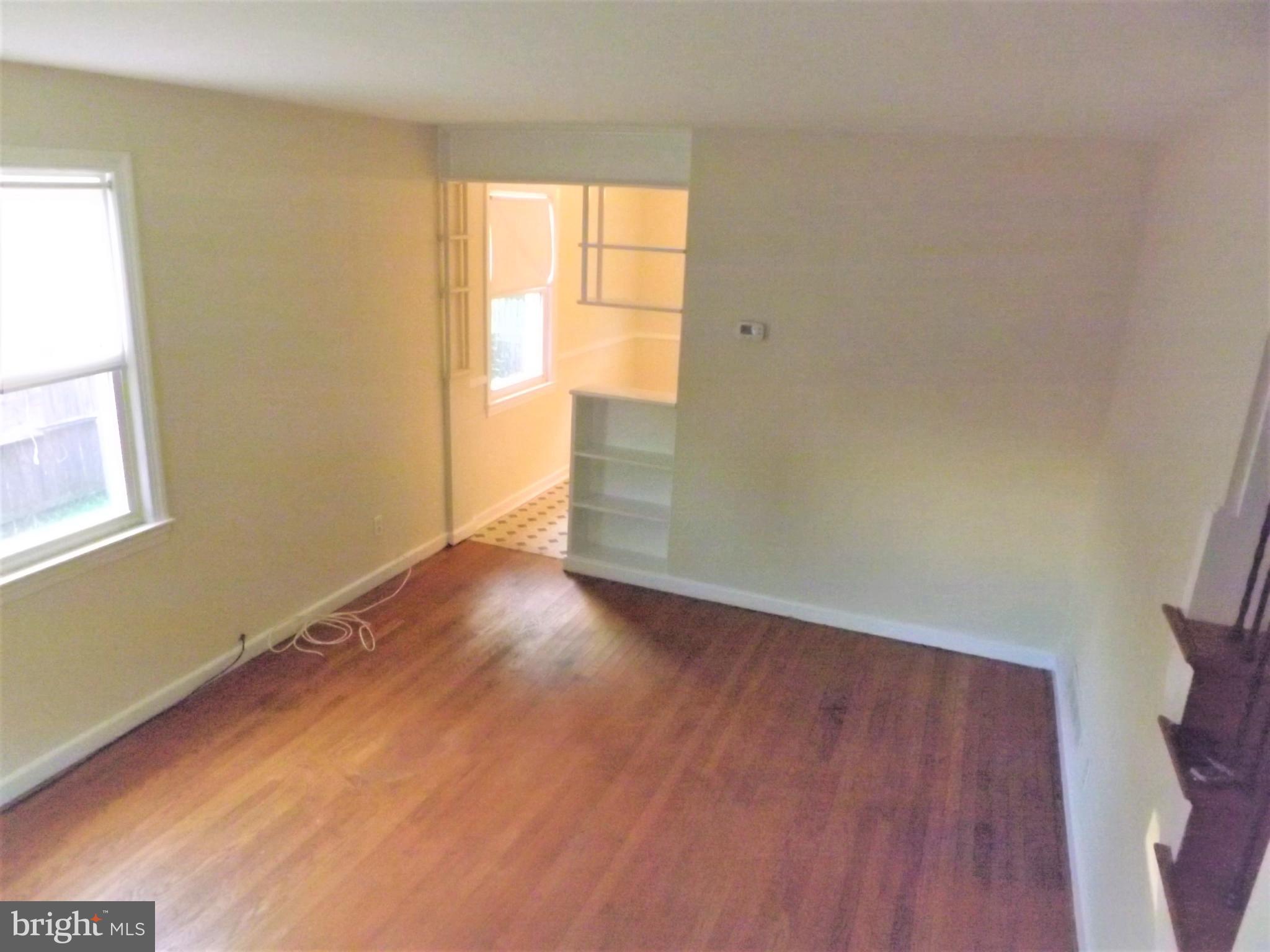 11936 Bluhill Road Silver Spring, MD 20902 - Photo 4 of 30 an empty room with wooden floor and windows