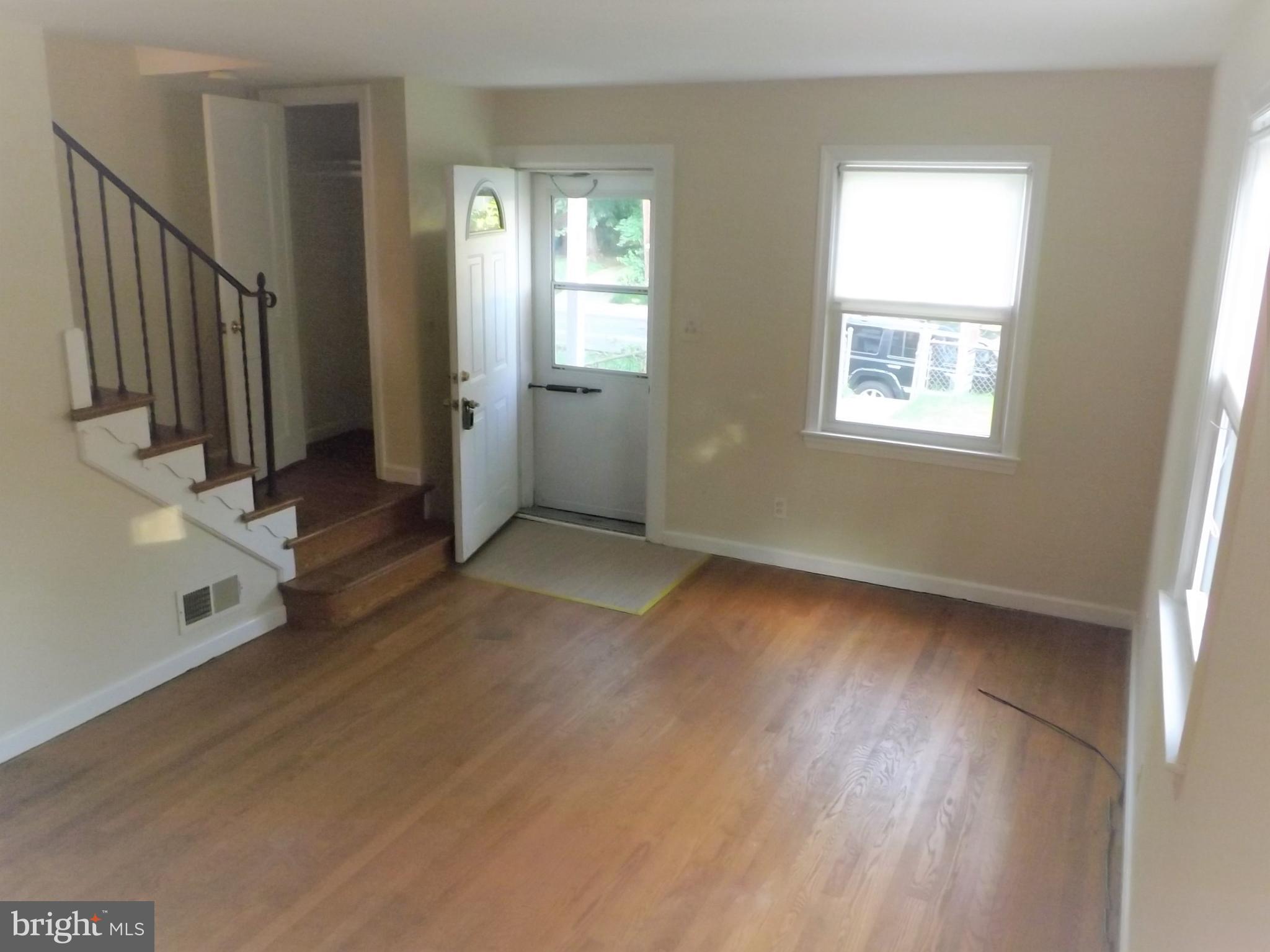 11936 Bluhill Road Silver Spring, MD 20902 - Photo 5 of 30 a view of livingroom with hardwood floor and window