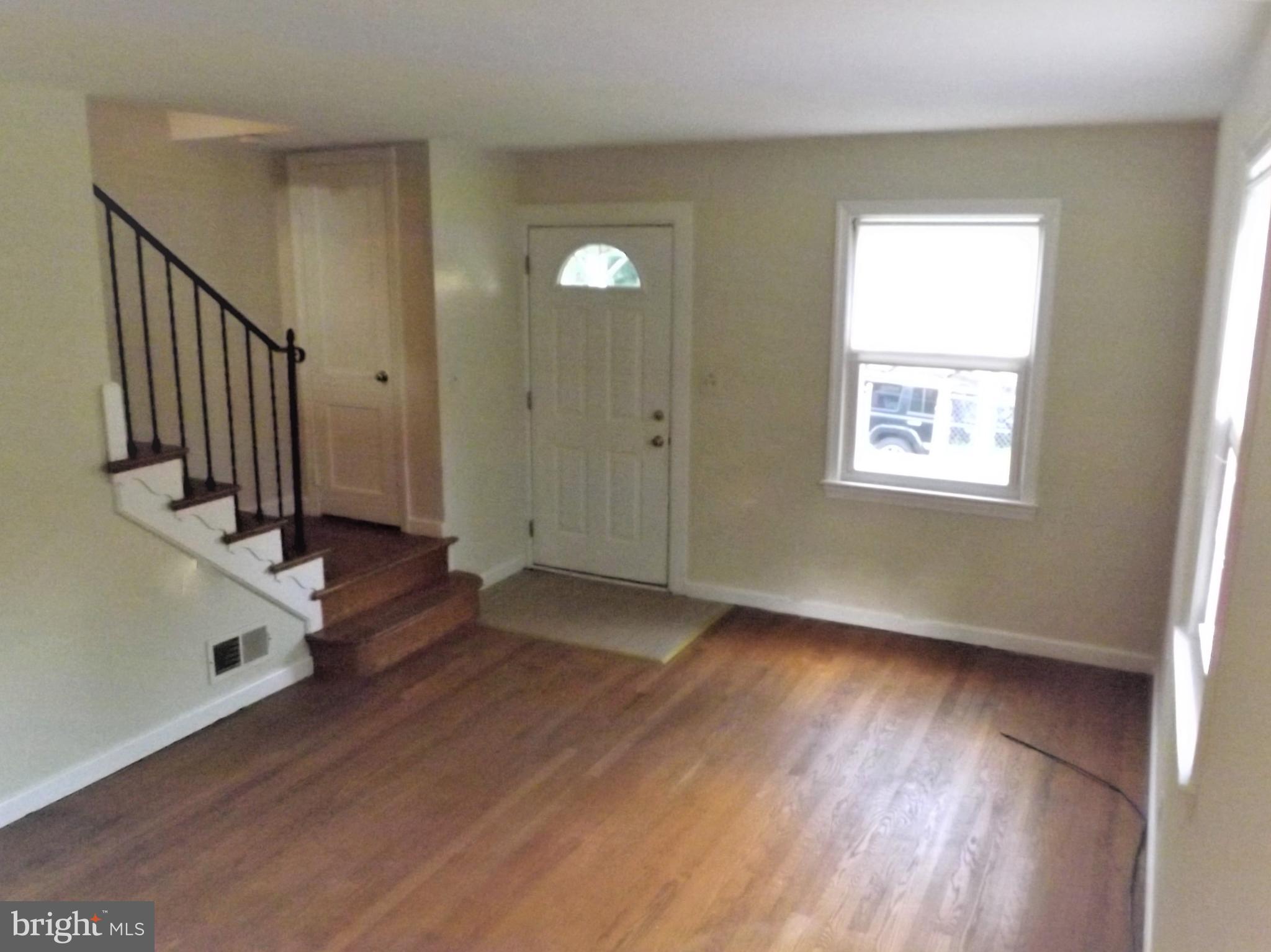 11936 Bluhill Road Silver Spring, MD 20902 - Photo 6 of 30 an empty room with wooden floor and windows