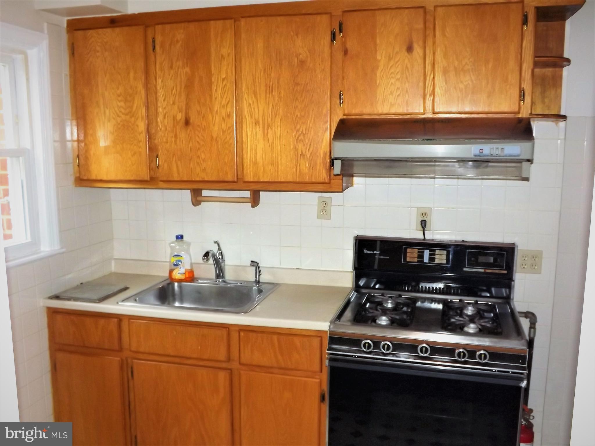 11936 Bluhill Road Silver Spring, MD 20902 - Photo 9 of 30 a kitchen with a stove and a sink