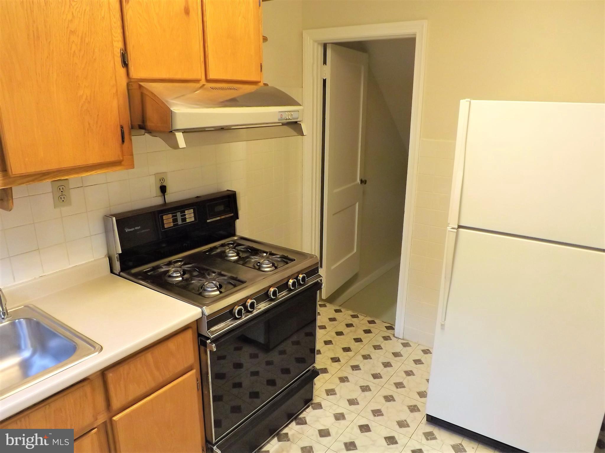 11936 Bluhill Road Silver Spring, MD 20902 - Photo 10 of 30 a stove top oven sitting inside of a kitchen