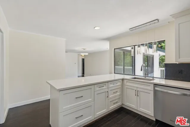 a bathroom with a sink toilet double vanity and shower