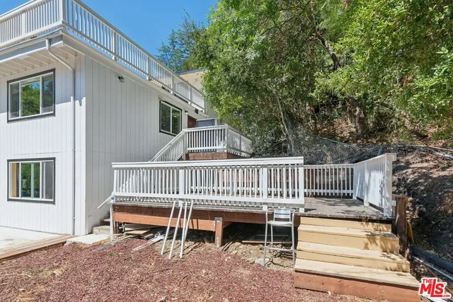 an aerial view of a house with a yard and trees