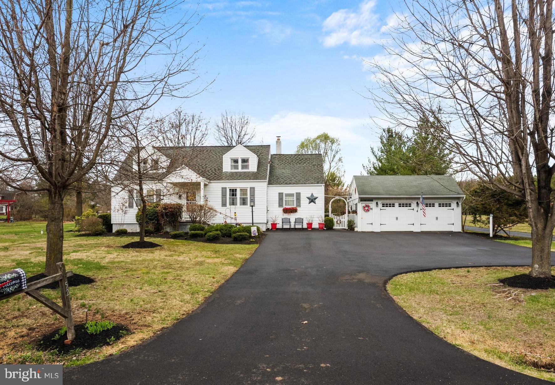 a view of a house with snow on the side of the road
