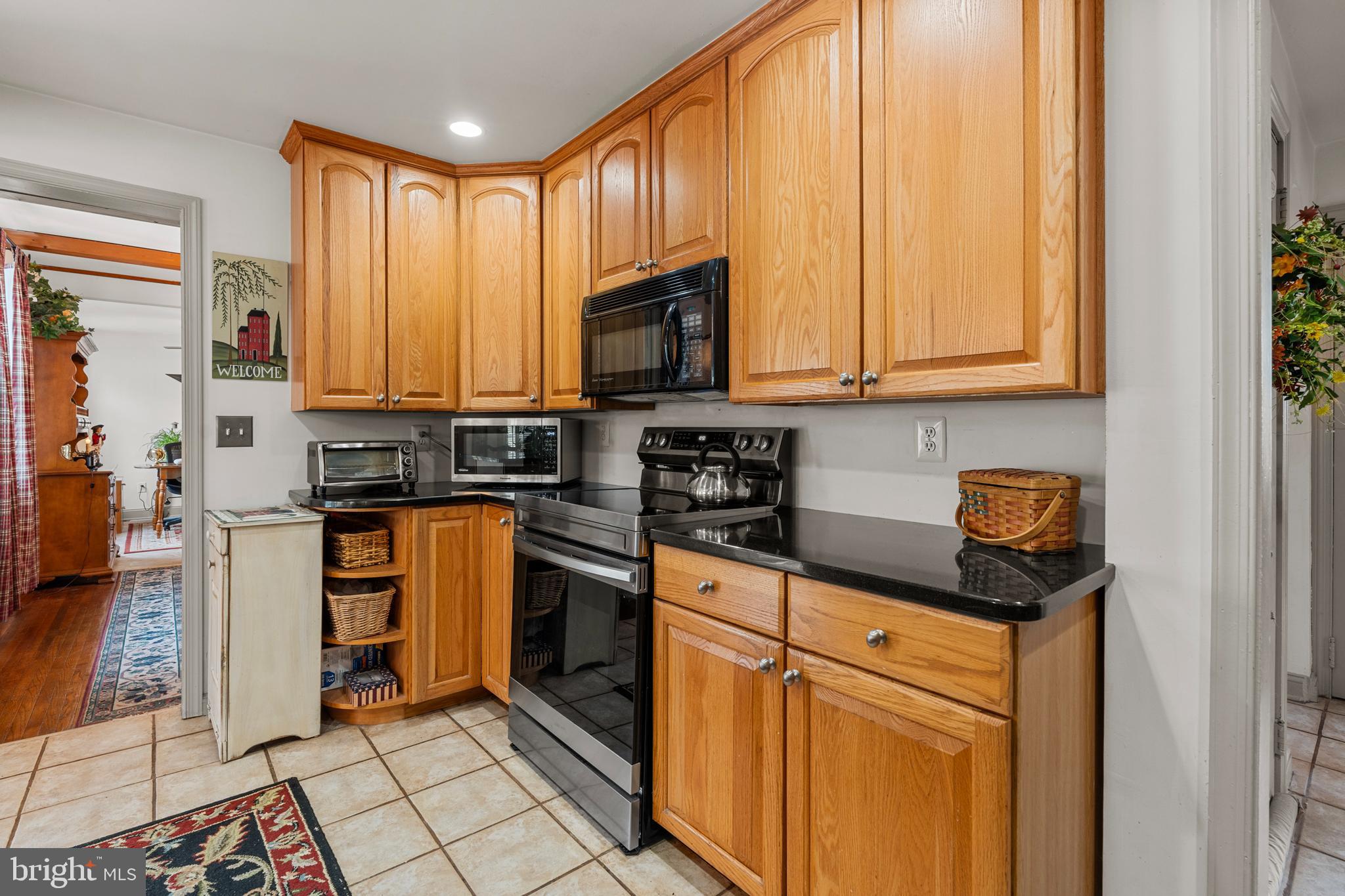 524 Scott Road Perkasie, PA 18944 - Photo 11 of 38 a kitchen with stainless steel appliances granite countertop a stove a sink and a microwave