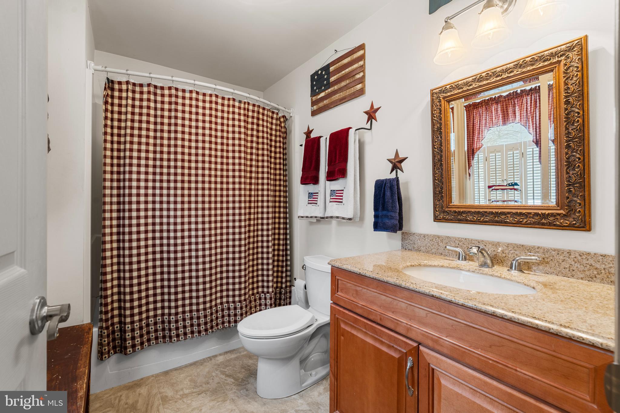524 Scott Road Perkasie, PA 18944 - Photo 19 of 38 a bathroom with a toilet sink vanity and mirror