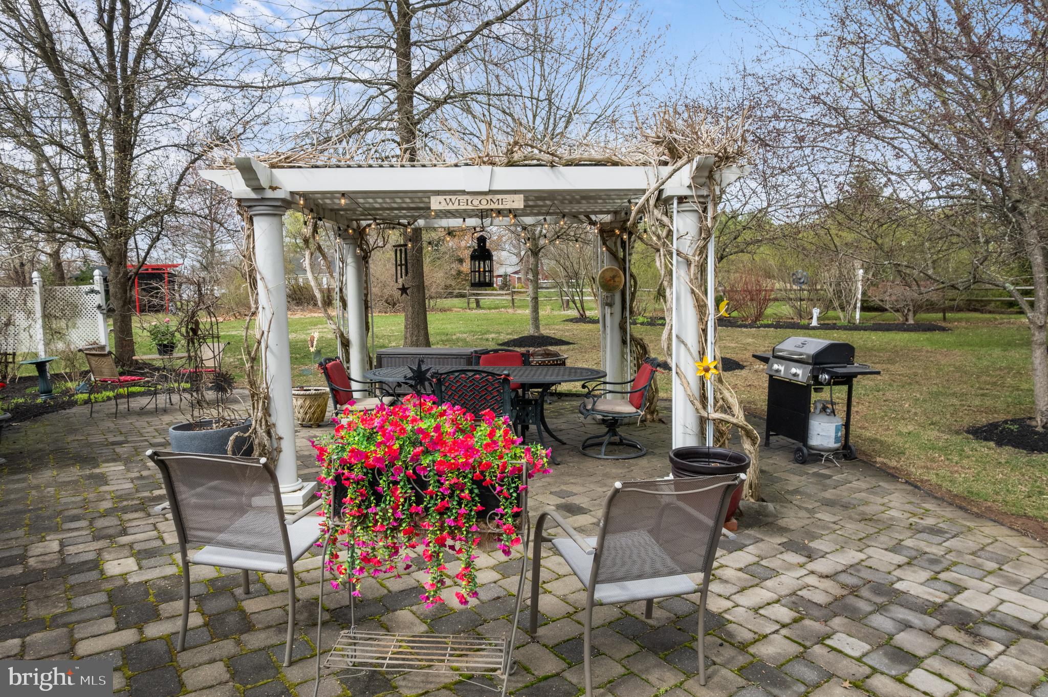 524 Scott Road Perkasie, PA 18944 - Photo 36 of 38 a view of a patio with table and chairs potted plants and large tree