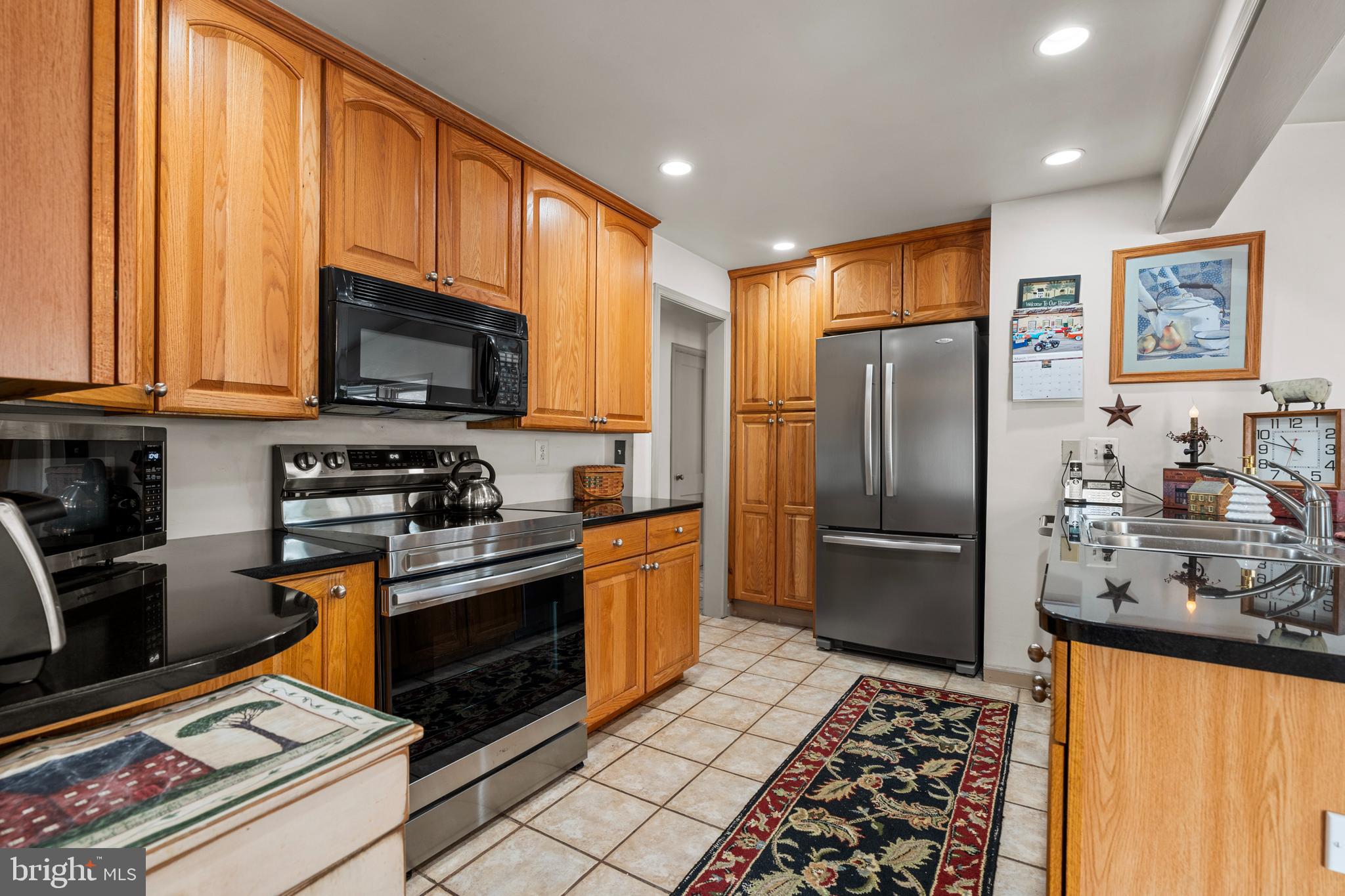 524 Scott Road Perkasie, PA 18944 - Photo 10 of 38 a kitchen with stainless steel appliances granite countertop a refrigerator stove and sink