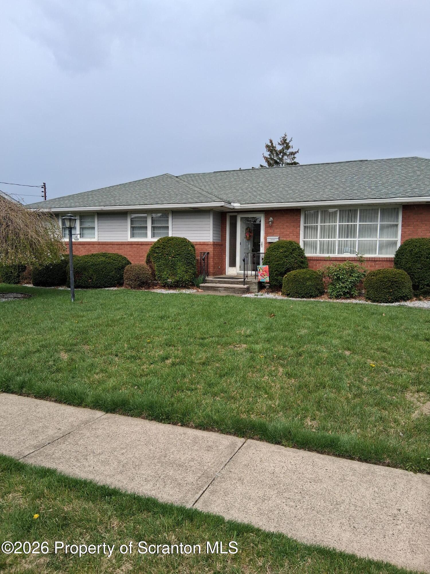 5 Monarch Road Wilkes Barre, PA 18706 - Photo 2 of 35 a front view of a house with a yard and garage