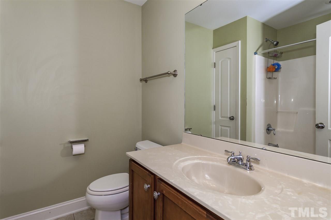 5607 Spring Glen Lane Raleigh, NC 27616 - Photo 15 of 21 a bathroom with a granite countertop sink toilet and shower