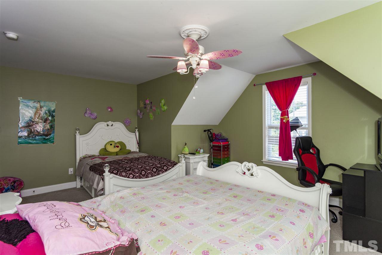 5607 Spring Glen Lane Raleigh, NC 27616 - Photo 17 of 21 a bedroom with a bed dresser and window