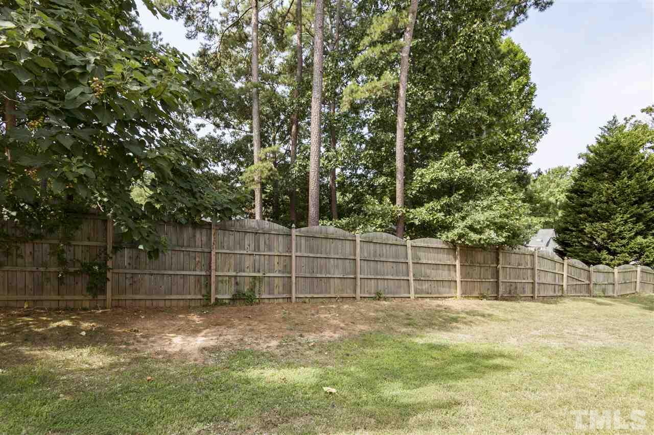 5607 Spring Glen Lane Raleigh, NC 27616 - Photo 20 of 21 a backyard of a house with a small garden
