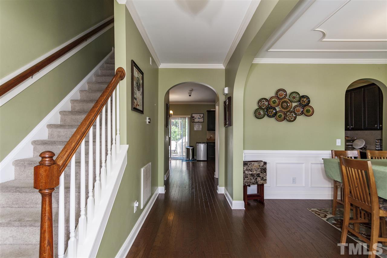 5607 Spring Glen Lane Raleigh, NC 27616 - Photo 3 of 21 a view of a hallway with wooden floor and staircase