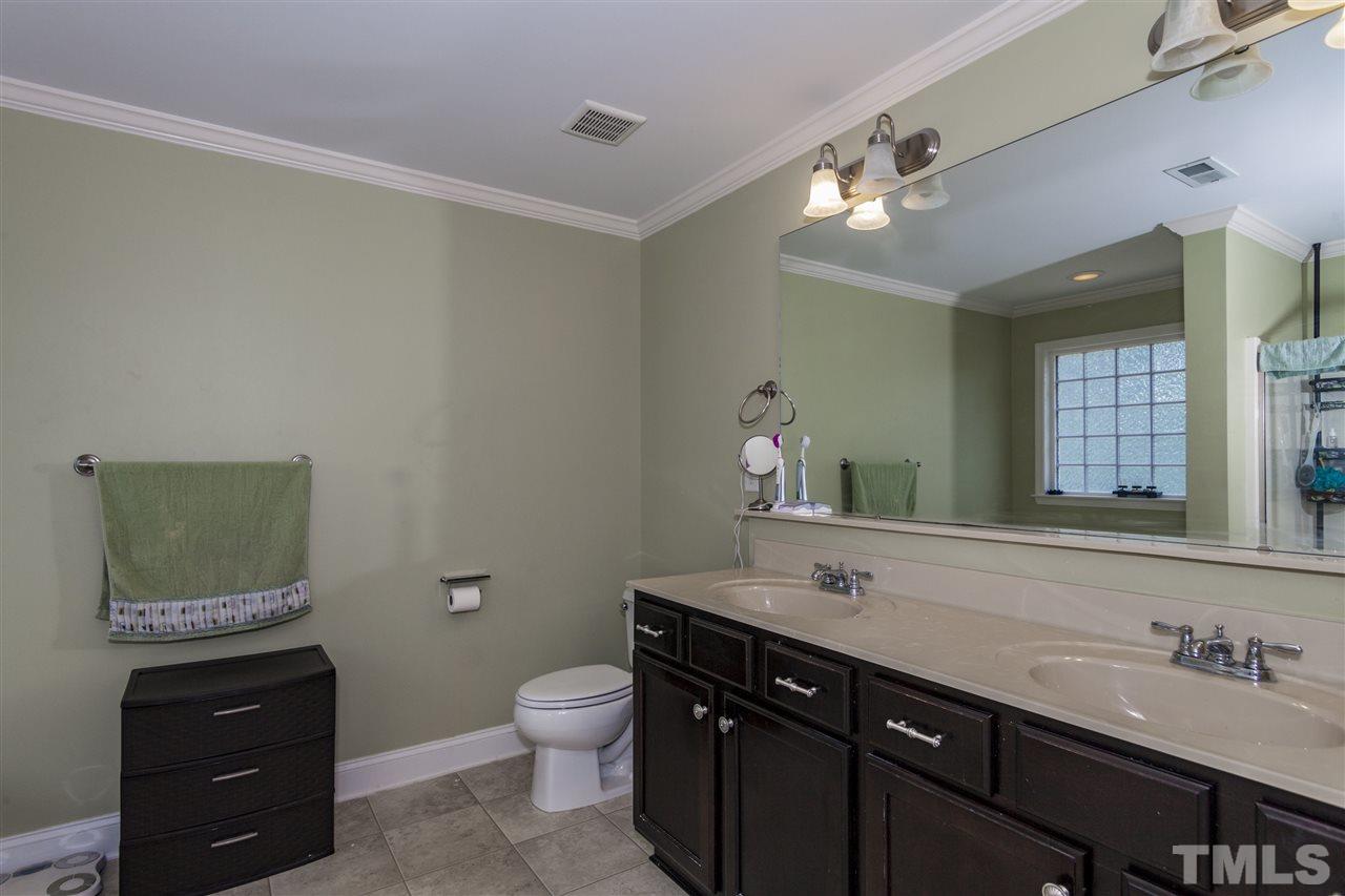 5607 Spring Glen Lane Raleigh, NC 27616 - Photo 10 of 21 a bathroom with a sink vanity and a mirror