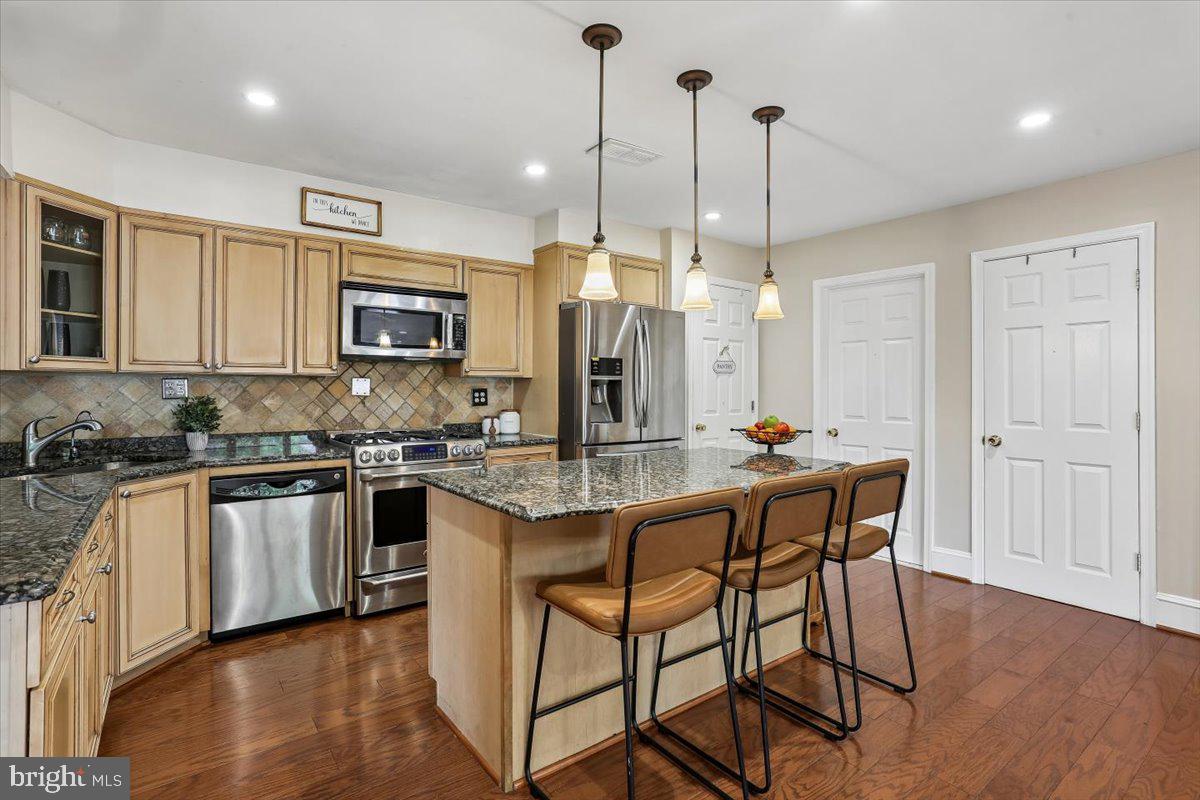 3709 Kenway Street Silver Spring, MD 20906 - Photo 2 of 34 a kitchen with stainless steel appliances kitchen island granite countertop a stove a sink and a refrigerator