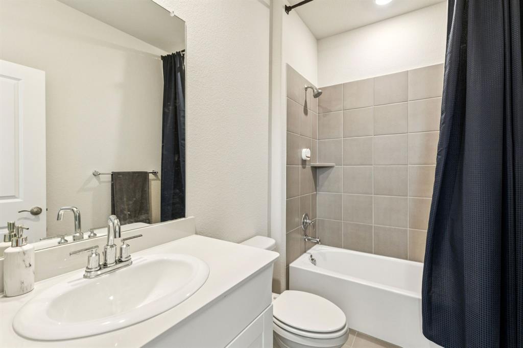 1008 Edgehurst Drive McKinney, TX 75071 - Photo 11 of 17 a bathroom with a bathtub shower sink and a toilet