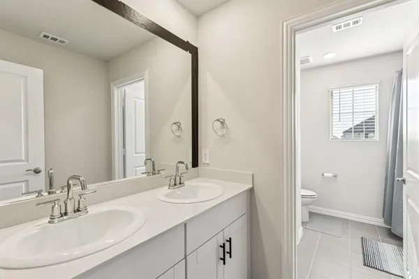 a bathroom with a bathtub shower sink and a toilet