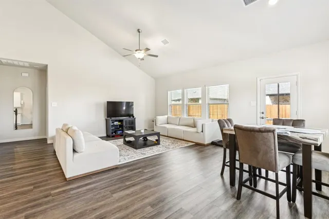 a kitchen with a sink cabinets and wooden floor