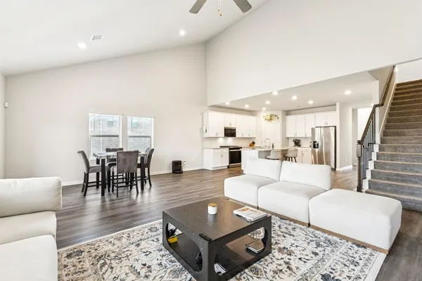 a living room with kitchen island furniture and a wooden floor