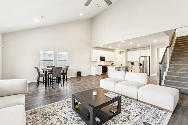 a living room with kitchen island furniture and a wooden floor