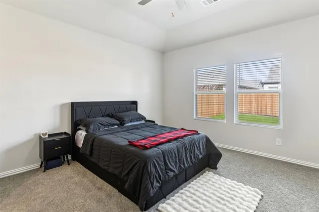 a living room with furniture a wooden floor and kitchen view