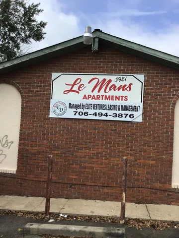 front view of a house with a tree