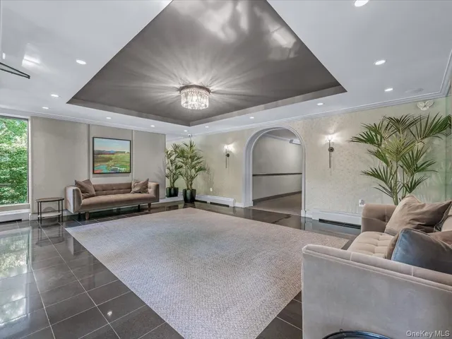 a living room with furniture and a chandelier