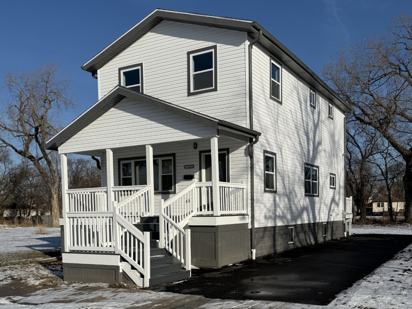 a view of a white house with iron fence