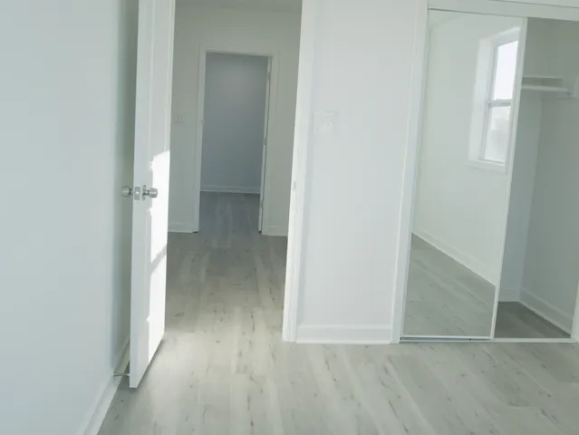 a view of hallway with wooden floor